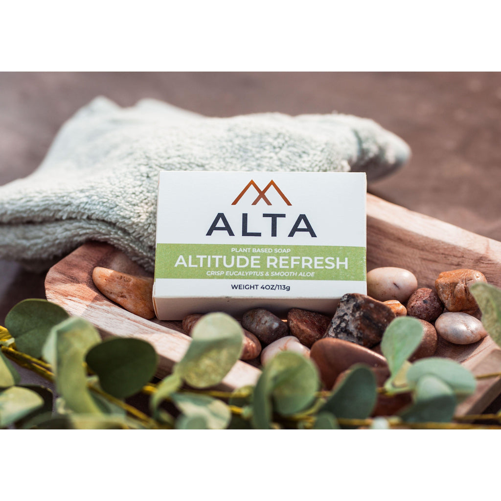 Altitude Refresh natural bar soap by Alta Body. A green and white cold-process soap bar featuring eucalyptus, aloe vera, and peppermint leaves.