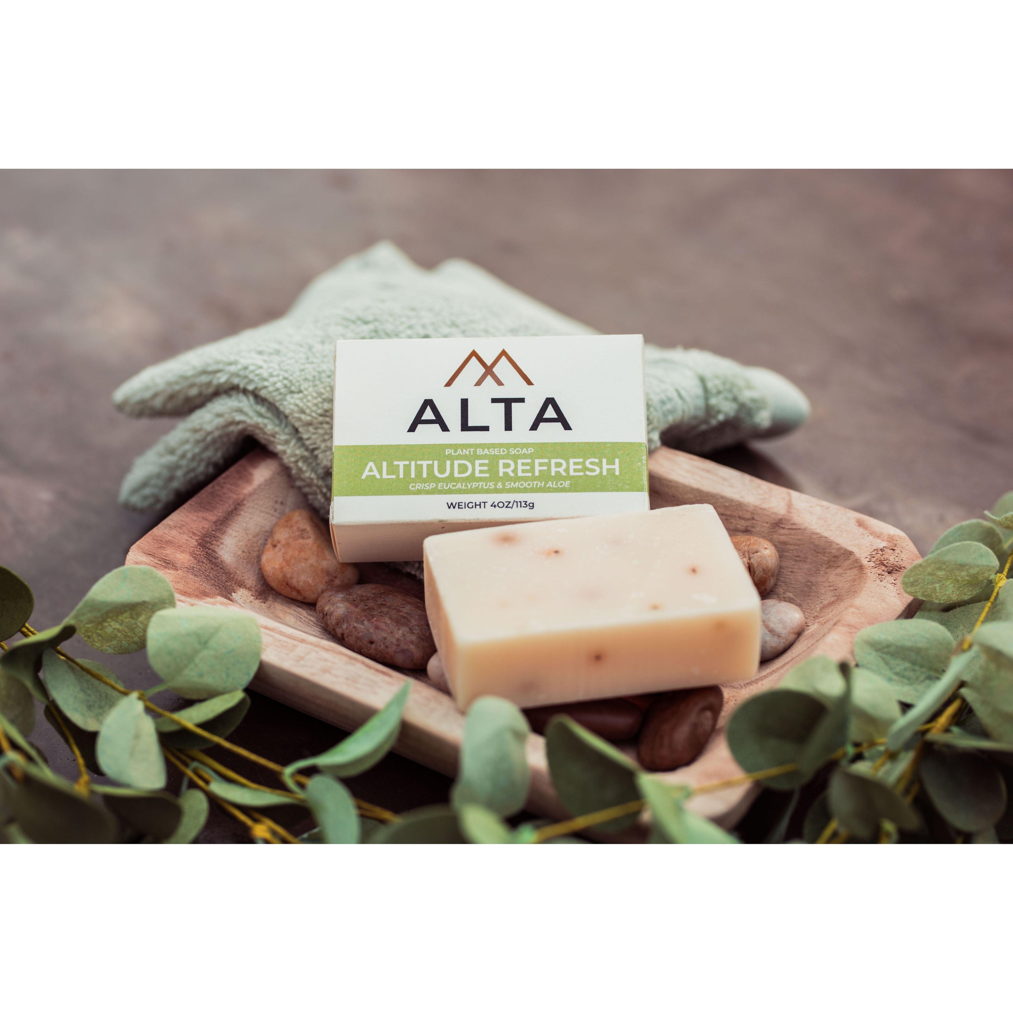 Altitude Refresh natural bar soap by Alta Body. A green and white cold-process soap bar featuring eucalyptus, aloe vera, and peppermint leaves.