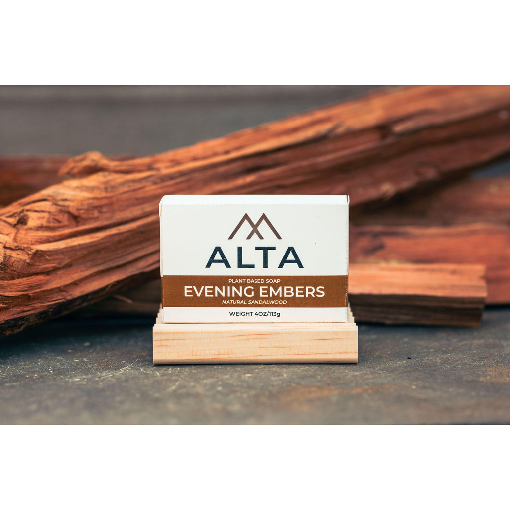 Evening Embers natural bar soap by Alta Body. A warm-toned, woodsy sandalwood cold-process soap bar placed on a natural wood surface.