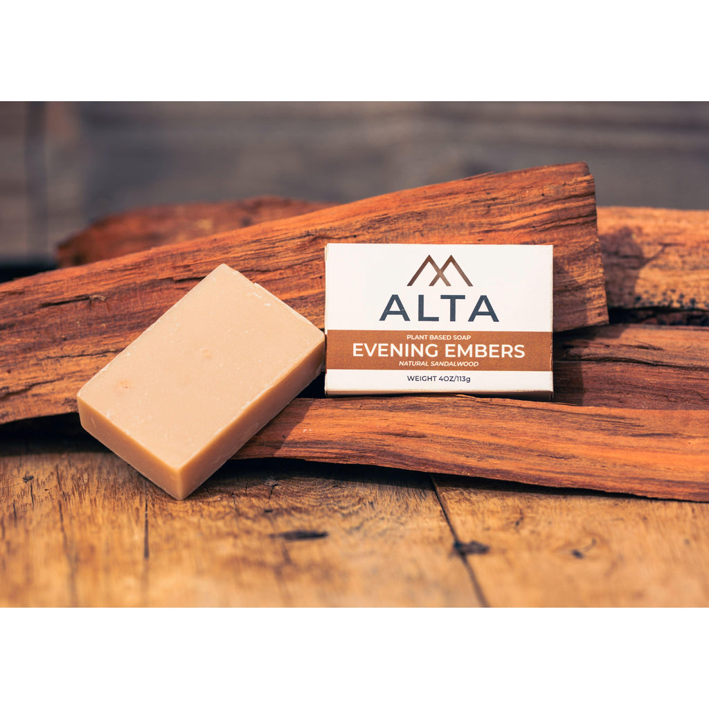 Evening Embers natural bar soap by Alta Body. A warm-toned, woodsy sandalwood cold-process soap bar placed on a natural wood surface.