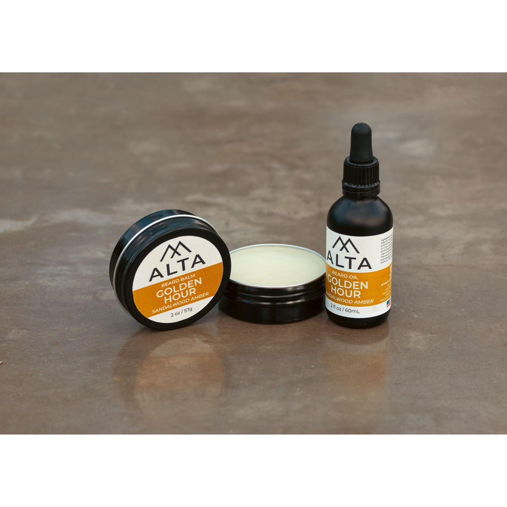 Alta Body Golden Hour Premium Beard Balm in a black 2oz tin. Sandalwood and Amber scented beard styling balm with Matcha Tea Butter.