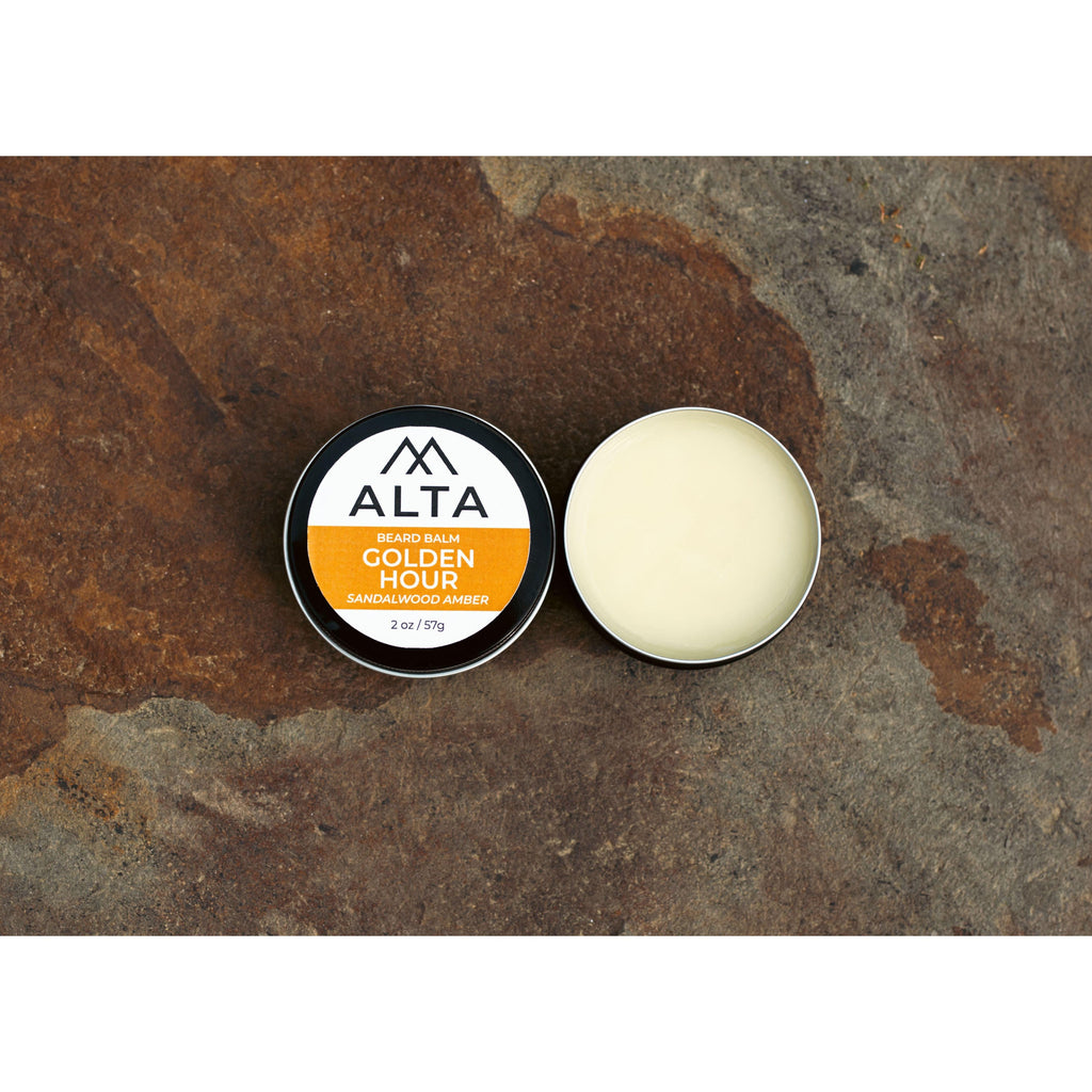 Alta Body Golden Hour Premium Beard Balm in a black 2oz tin. Sandalwood and Amber scented beard styling balm with Matcha Tea Butter.
