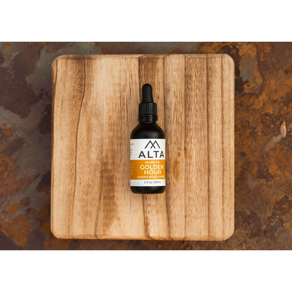 Alta Body Golden Hour Premium Beard Oil in a 2oz glass dropper bottle. Sandalwood and Amber scented natural beard conditioner.