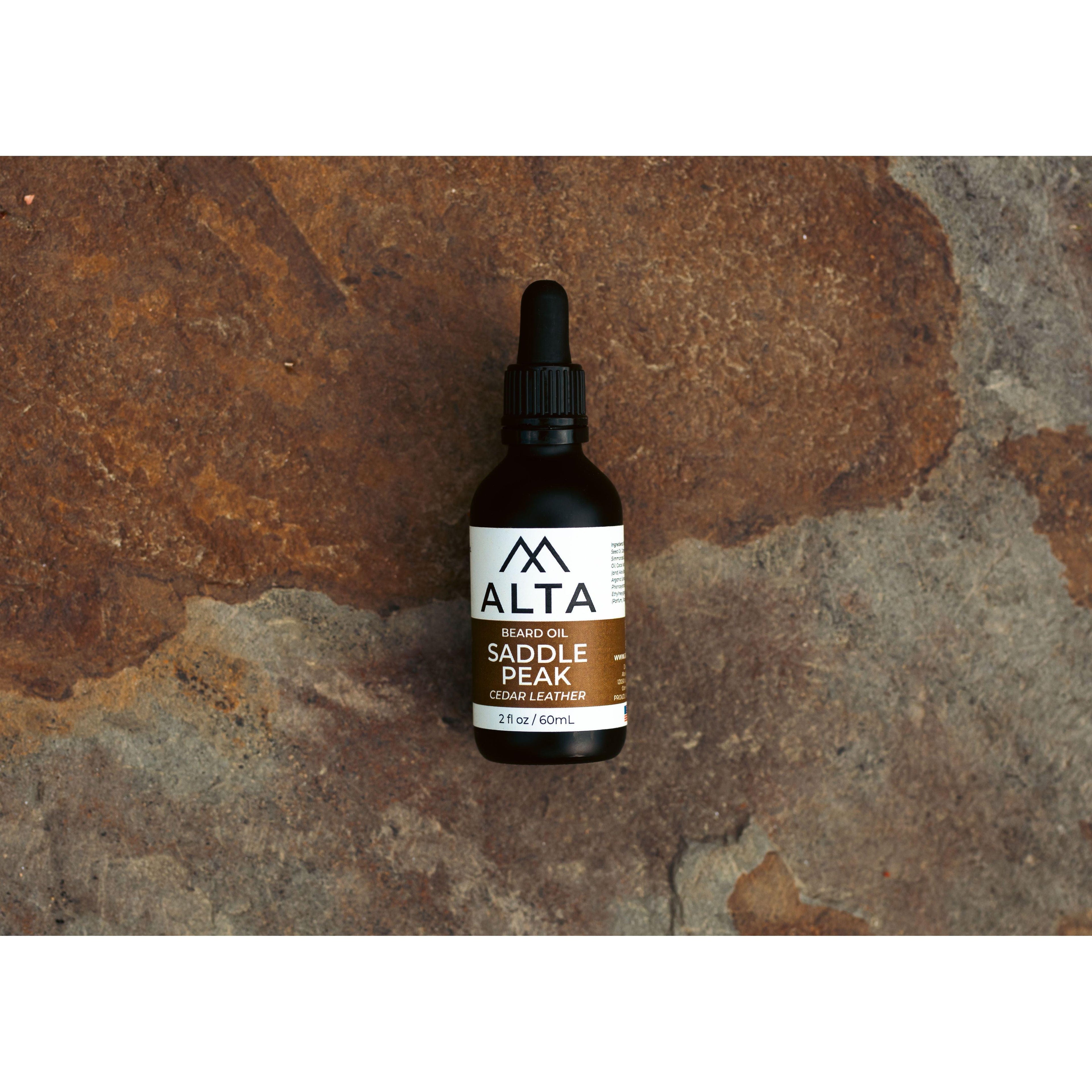Alta Body Saddle Peak Premium Beard Oil in a 2oz glass dropper bottle. Cedar and Leather scented natural beard conditioner.