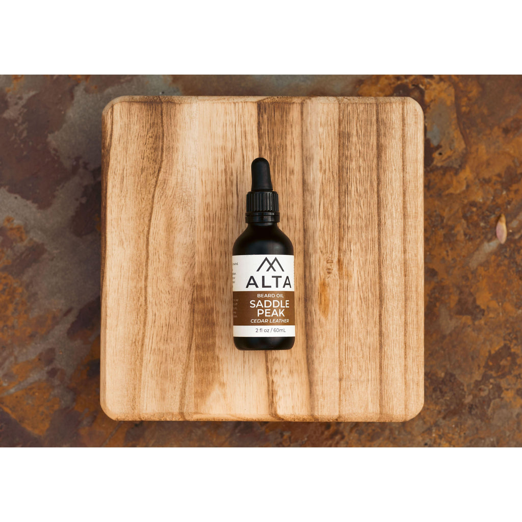 Alta Body Saddle Peak Premium Beard Oil in a 2oz glass dropper bottle. Cedar and Leather scented natural beard conditioner.