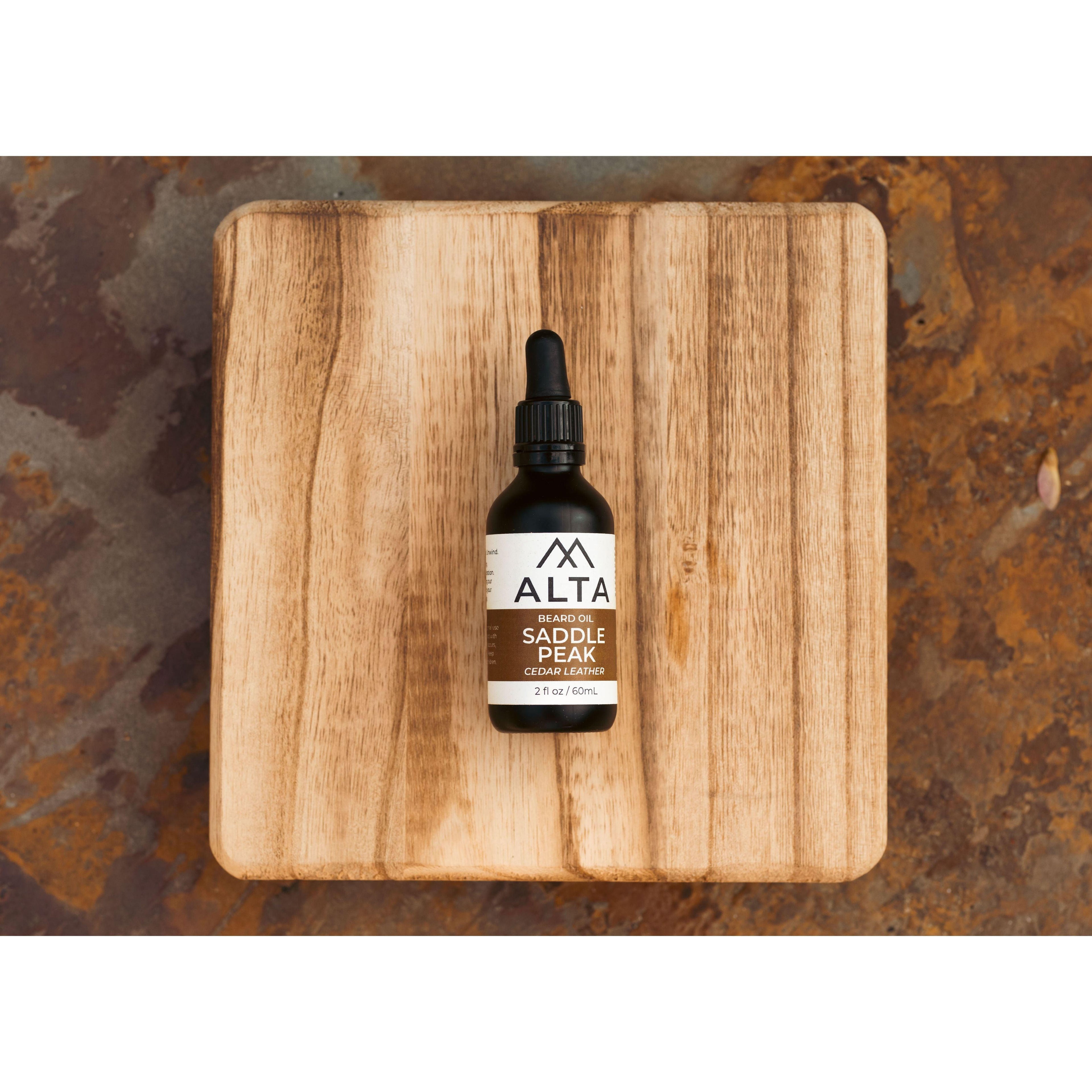 Alta Body Saddle Peak Premium Beard Oil in a 2oz glass dropper bottle. Cedar and Leather scented natural beard conditioner.